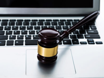 Gavel resting on top of a laptop keyboard.