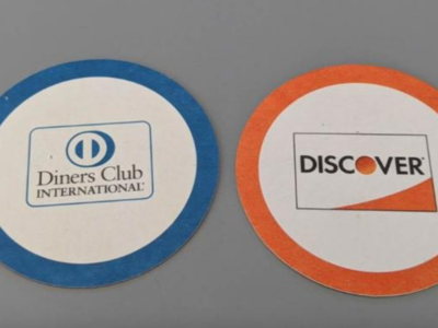 Blue coaster with Diners Club International logo and orange coaster with Discover logo.