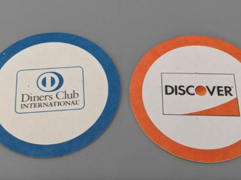 Blue coaster with Diners Club International logo and orange coaster with Discover logo.