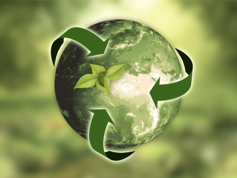 Green earth with arrows and growing plant symbolizing sustainability in promotional products.